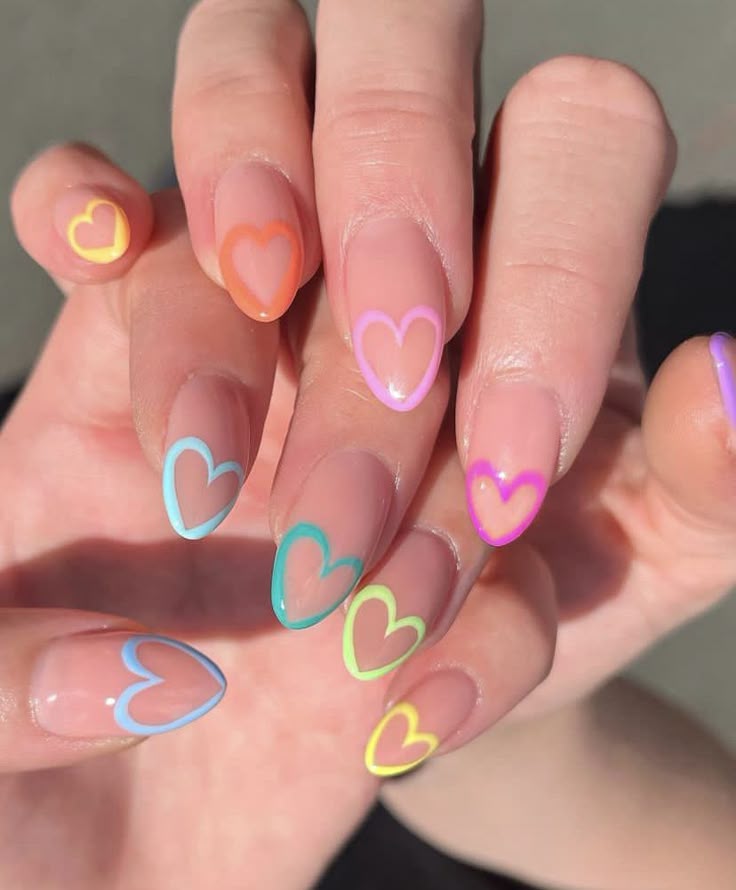 nails painted with a clear polish with a different coloured heart outline painted on the tip of each.