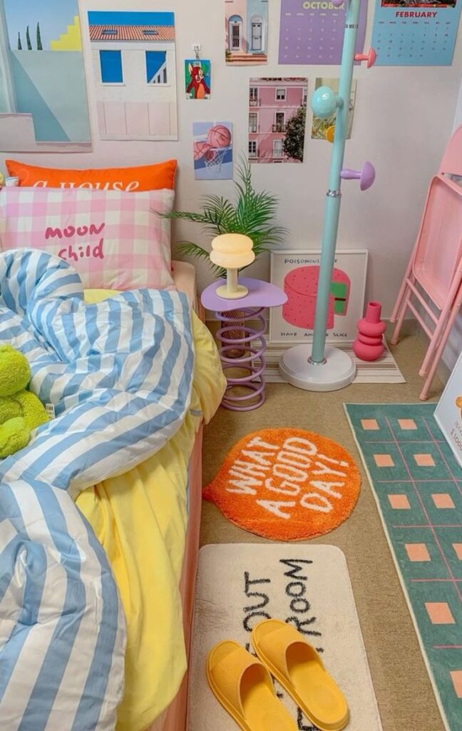 A small, vibrant dorm room featuring a bed with pastel strip and checked bedding