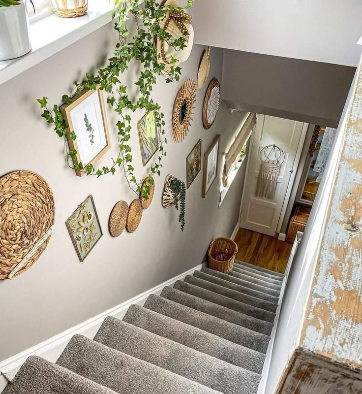 A staircase wall styled with a collection of decorative woven circular baskets and trailing greenery.