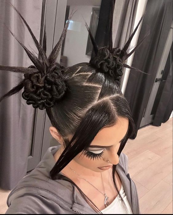 A portrait of a woman wearing a Y2K prom hair style with a high, spiked bun and thick front strands.