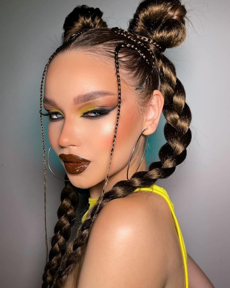 A portrait of a woman with Y2K prom hair featuring sleek braided space buns and micro-braids framing her face.
