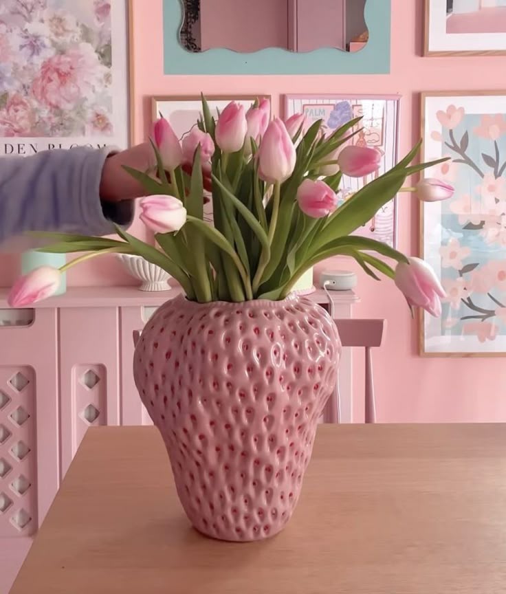 Pastel Pink Botanical AccentFor a softer take on the theme, a textured strawberry vase in a gentle pastel pink offers a sophisticated botanical touch. Fill it with fresh tulips to create a stunning centerpiece that complements a light and airy interior. This piece perfectly balances playful cottage-style with a modern, intentional color palette.