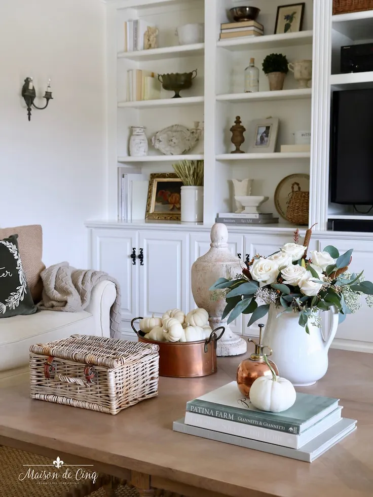 Farmhouse fall centerpiece idea with white pumpkins, copper planter, and rose arrangement