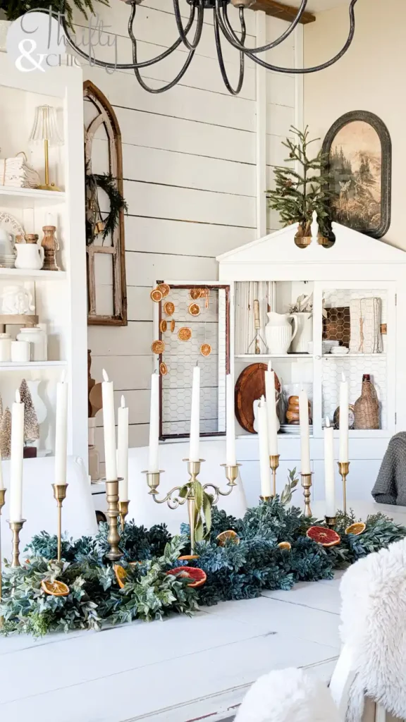 Winter tablescape decor idea with brass candlesticks and dried citrus garland