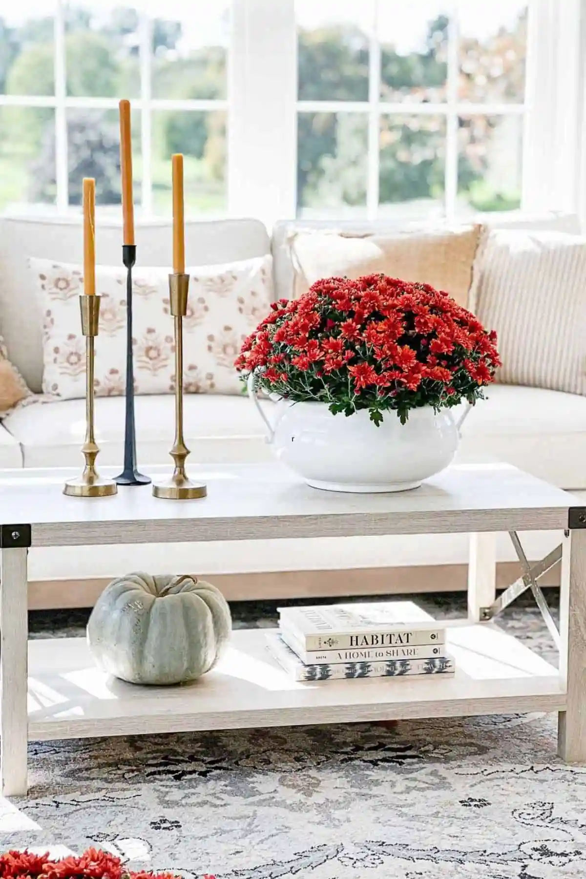 small rustic wood coffee table decor with a white vase of dried hydrangeas on a wooden board, vintage abacus and stacked books